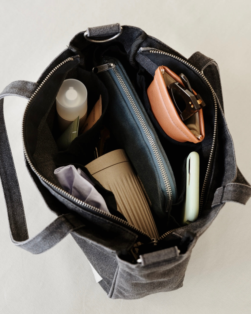 Smaller version of the bestselling everyday zip top pocket tote, with six internal pockets, in a versatile and casual style, and includes an adjustable and detachable strap. The perfect bag for days when you don’t need to carry everything.