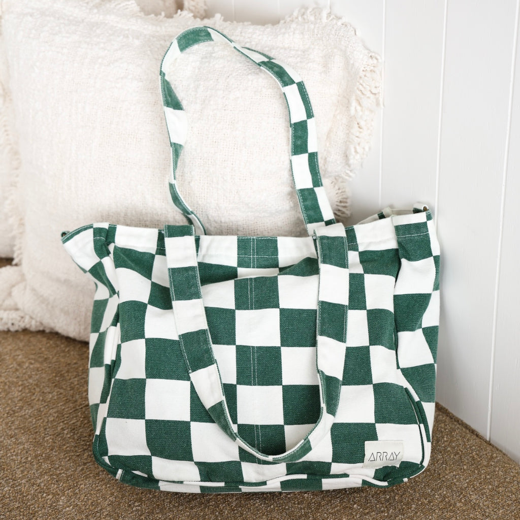 Green and white checkered bag with 'ARRAY' branding on a textured surface.